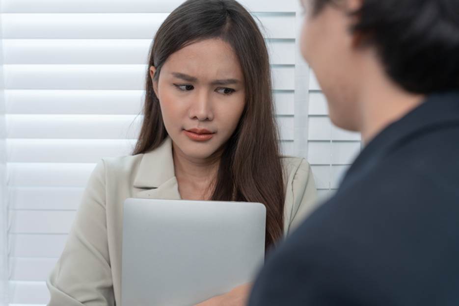 Woman looking concerned at work - Sexual Discrimination